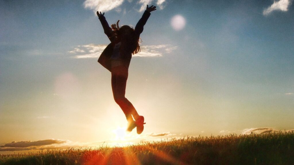 donna che salta al tramonto